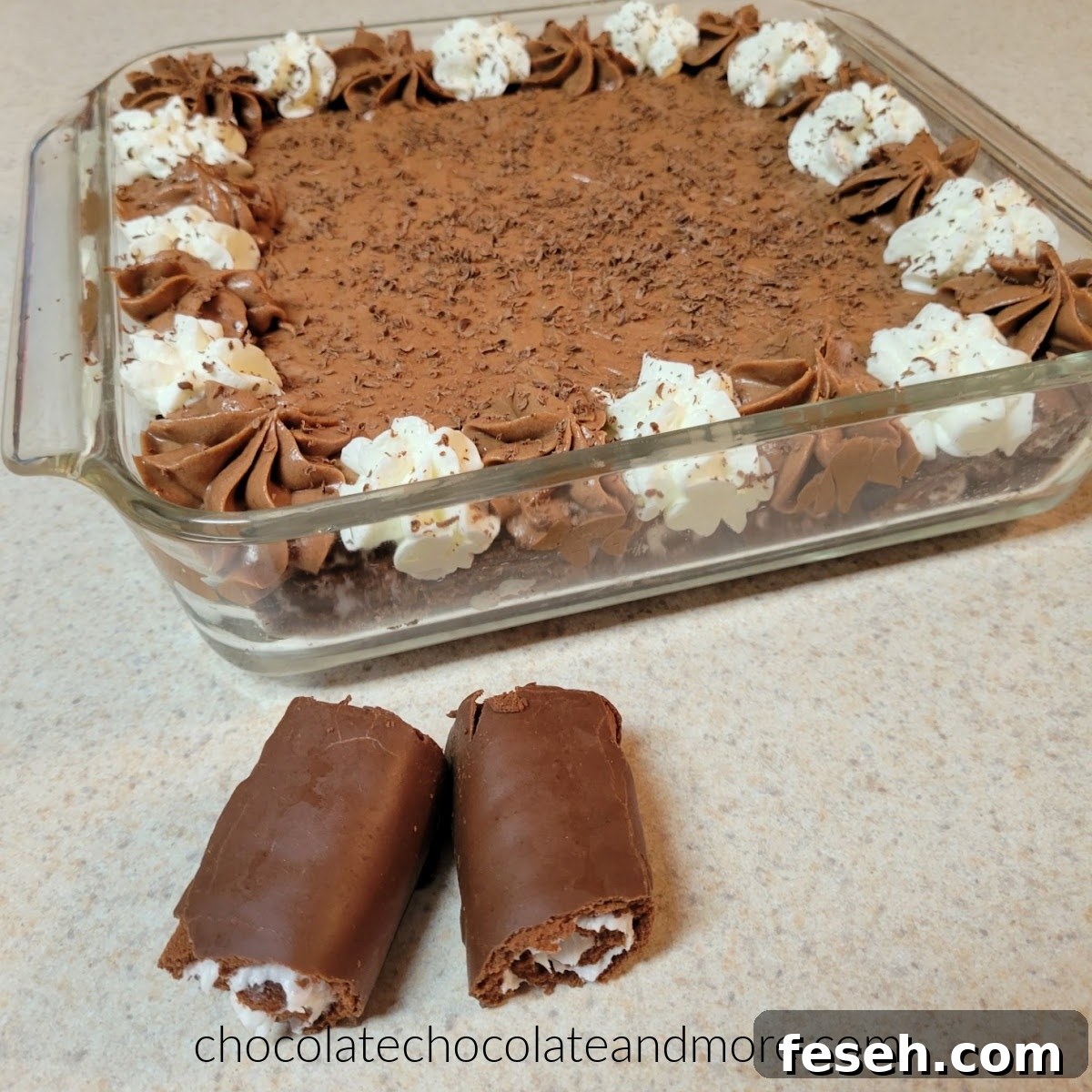 a glass dish filled with swiss roll slices and filled with chocolate mousse