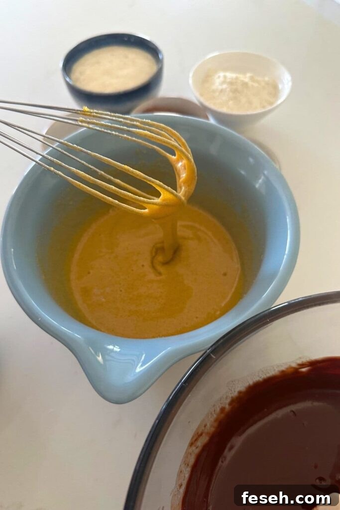 Folding the brownie batter in a bowl.
