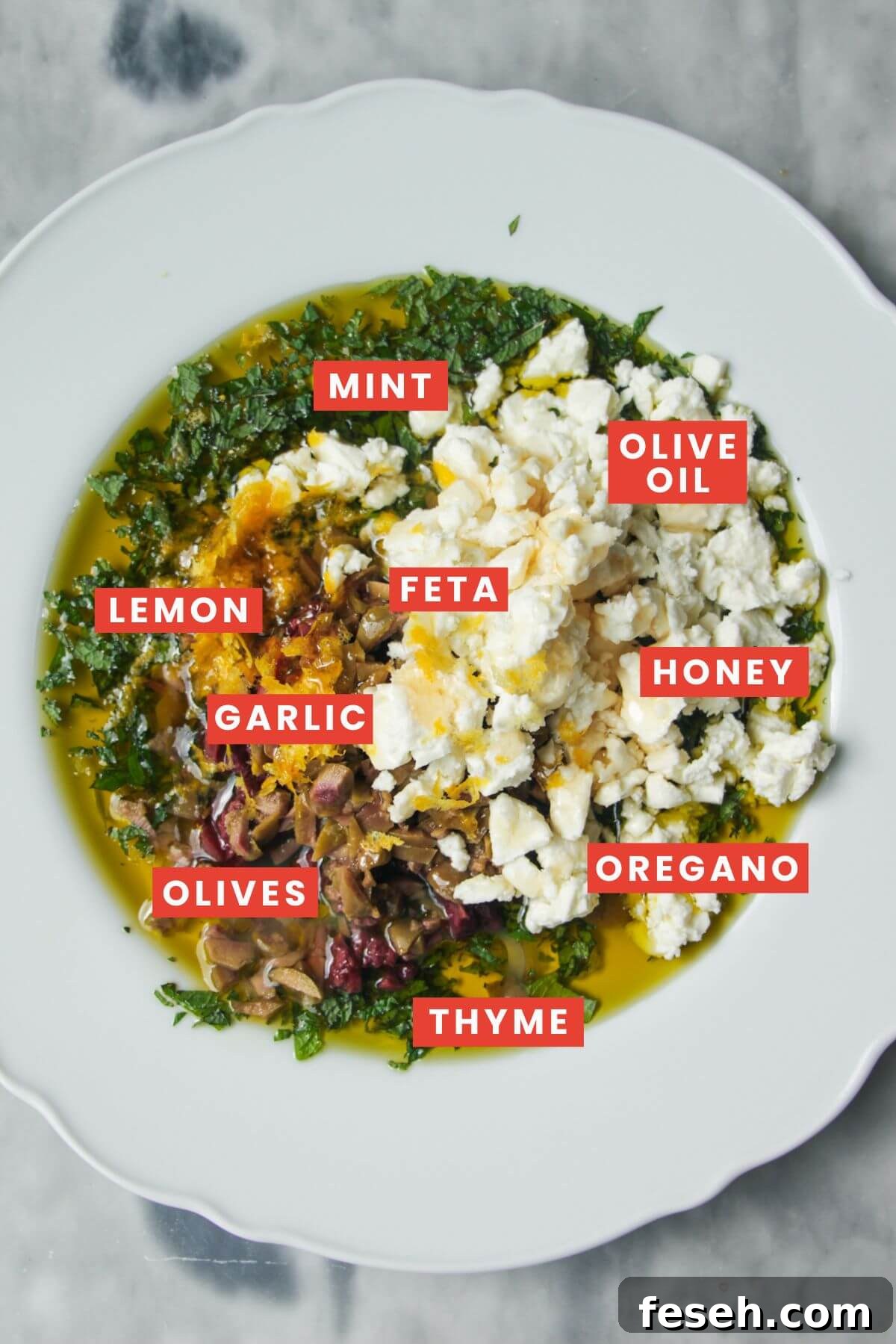 Ingredients in Greek dipping oil in a large white plate.