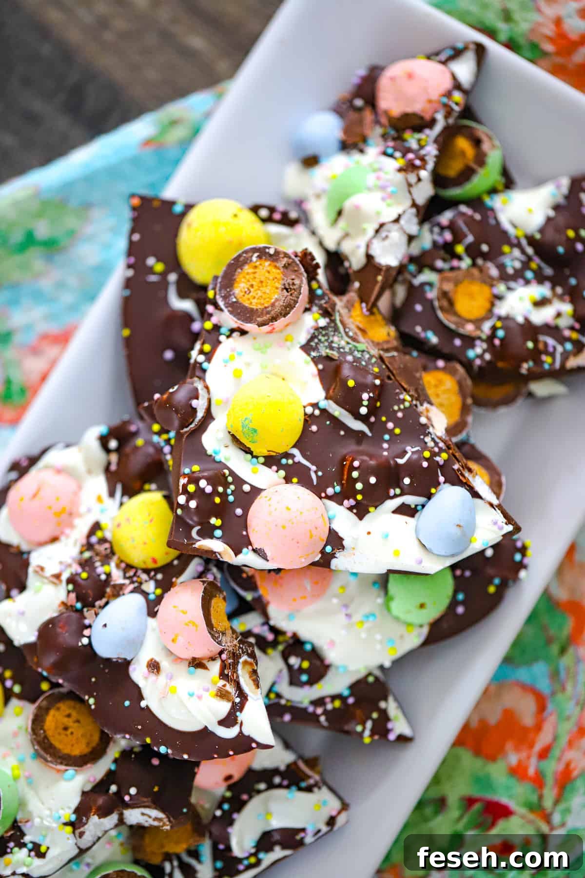 Colorful Easter candy bark with chocolate swirls and crunchy malted milk balls.