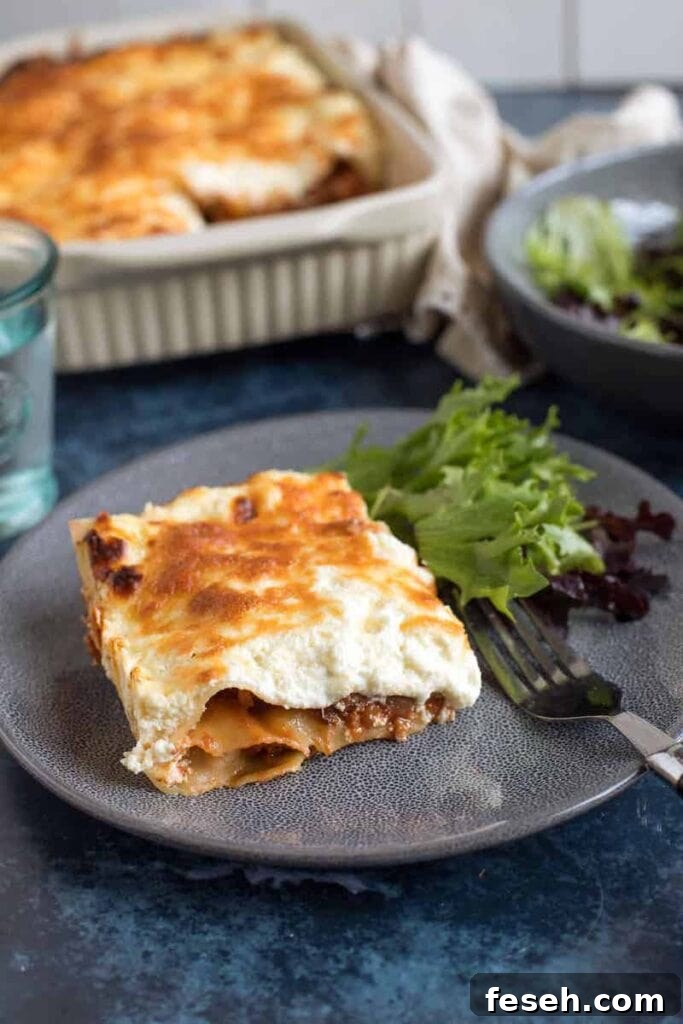 Effortless Foodie's Easy Lasagne served with a salad on a blue plate in the Winter Warming Oven Bakes CookBlogShare round up.
