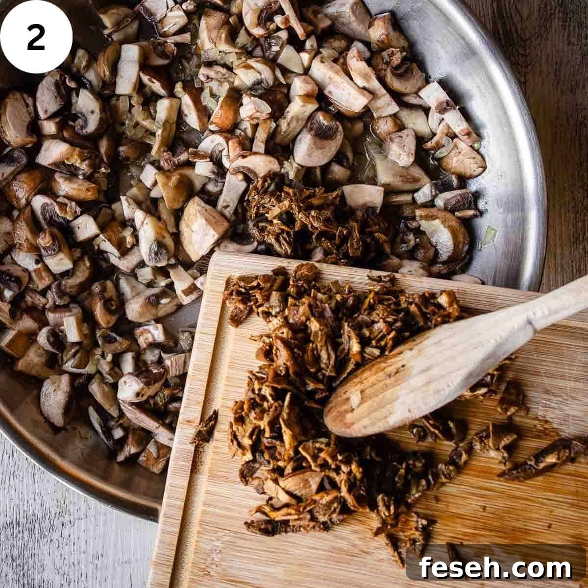 Adding chopped porcini mushrooms to a pan full of chopped mushrooms.