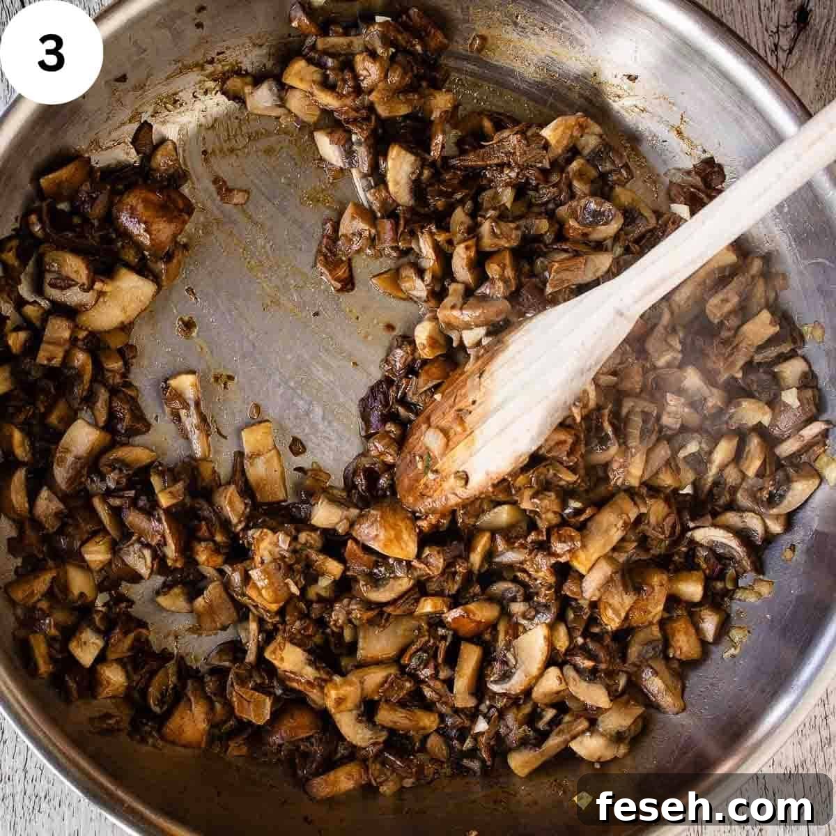 Cooked chopped mushrooms in a pan.