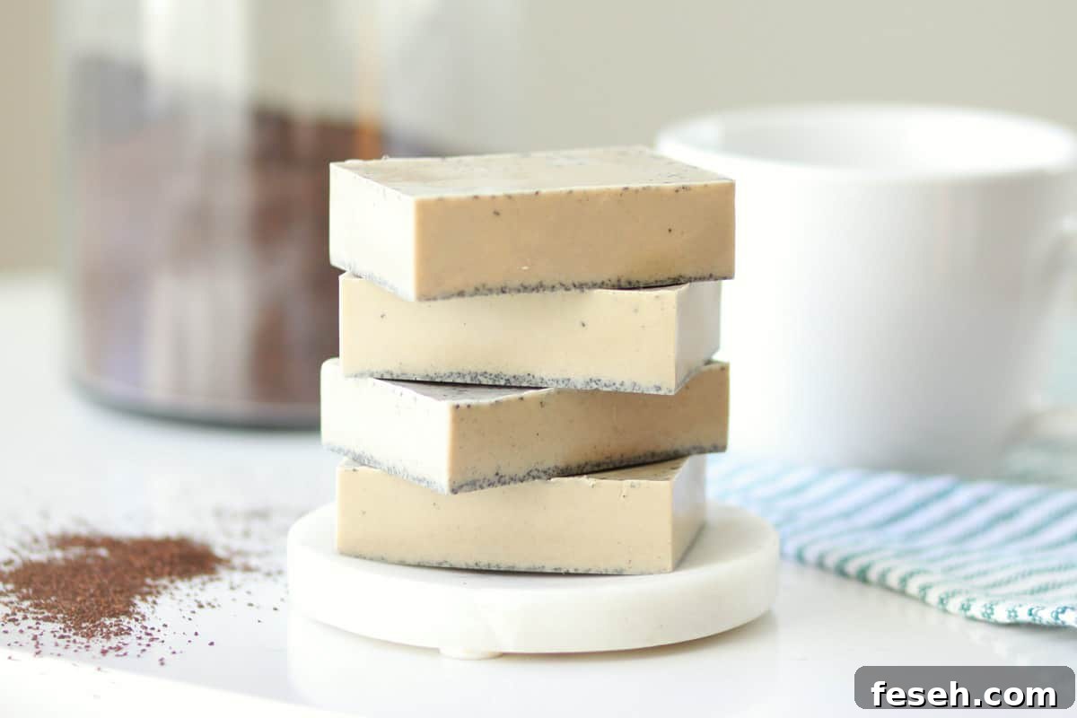 a stack of 4 bars of coffee soap on a soap dish