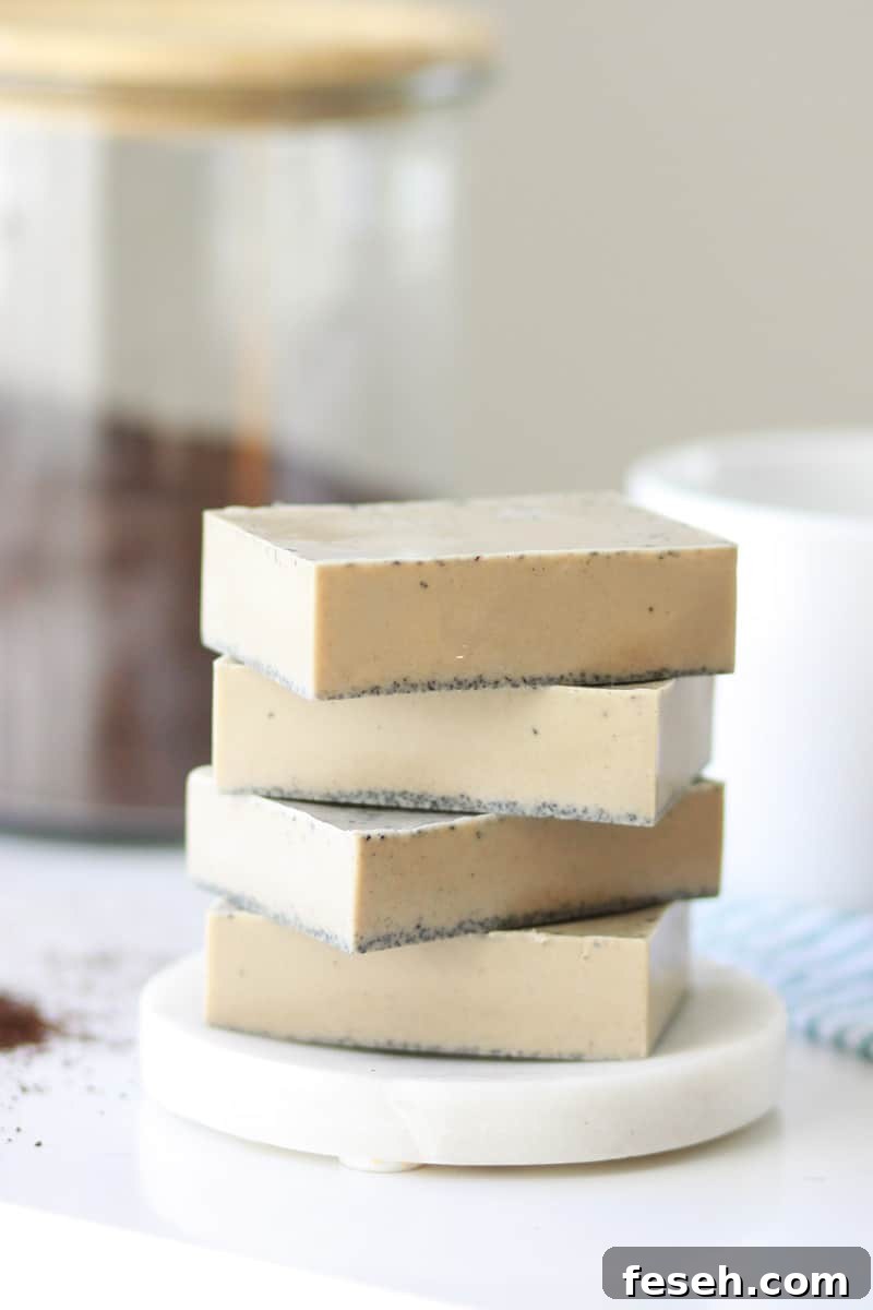 a stack of 4 bars of coffee soap on a soap dish