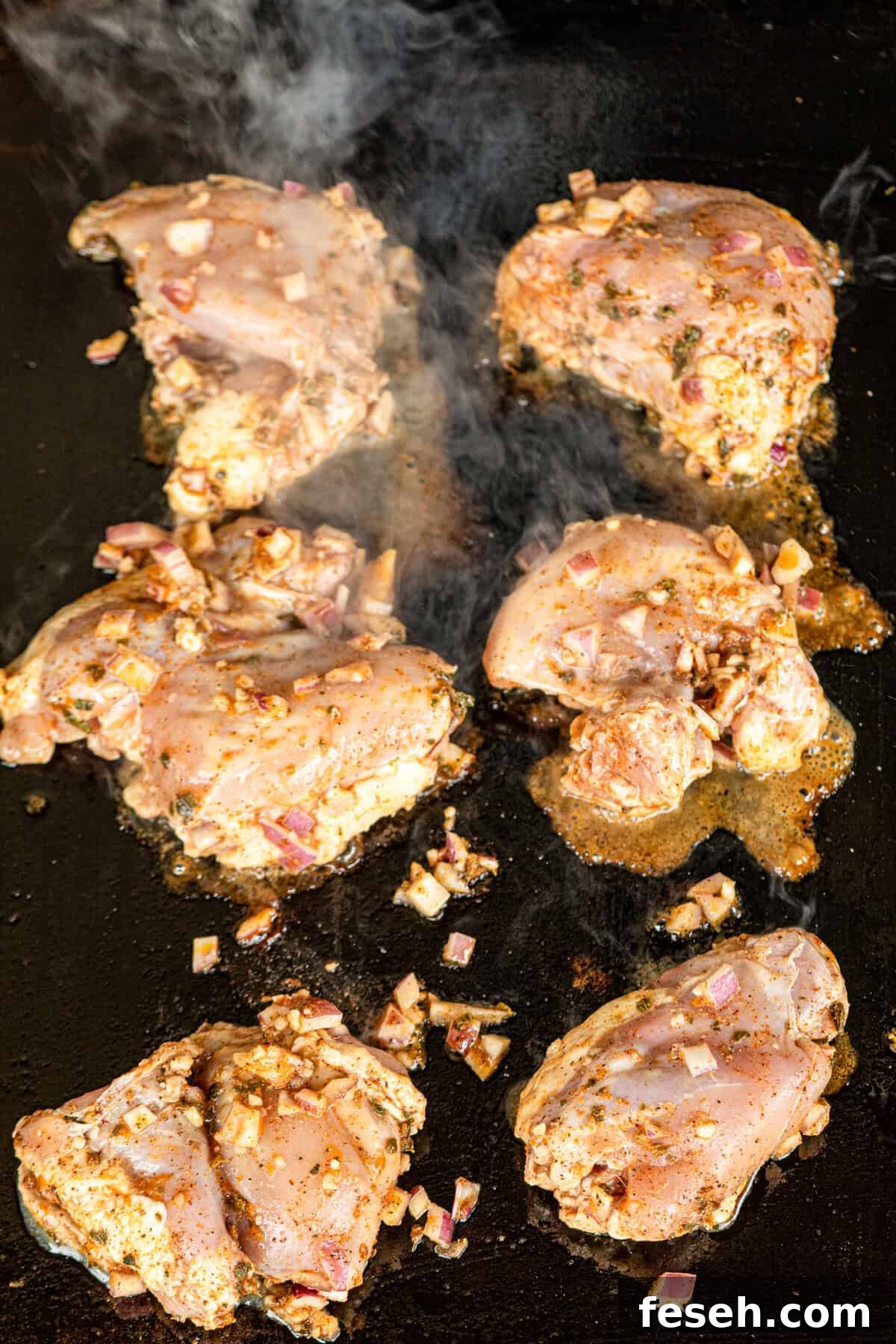 Marinaded chicken on Blackstone griddle for Pollo Asado recipe