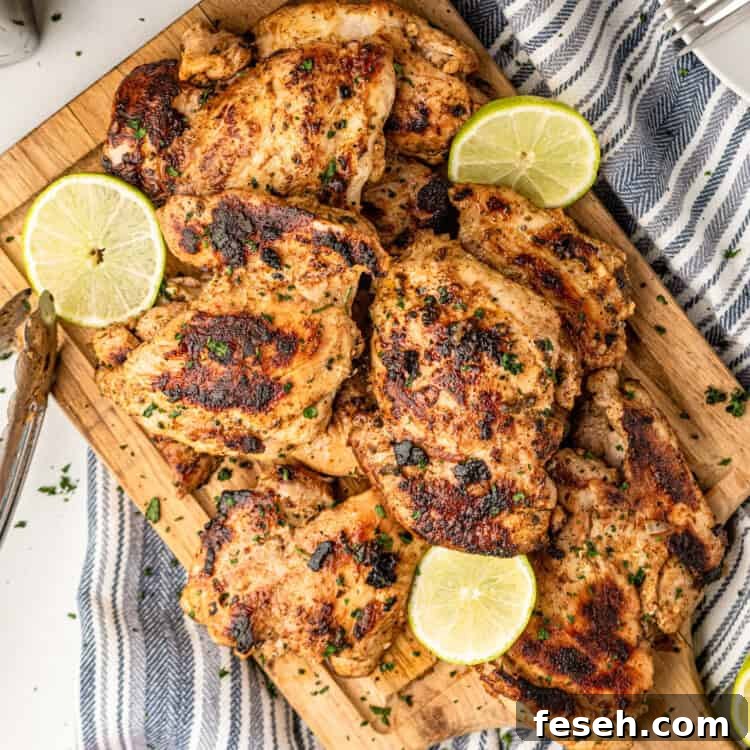 Pollo Asado on wooden cutting board with lemon and lime slices