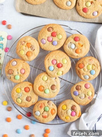Smarties cookies on a wire cooling rack.
