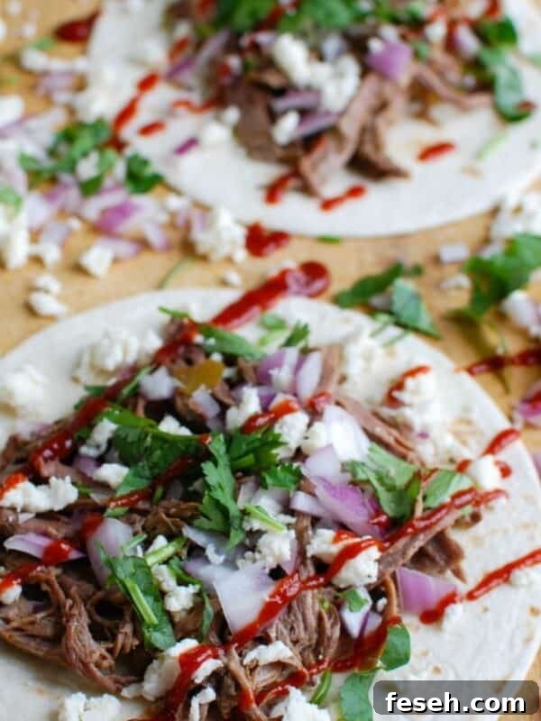 Slow Cooker Beef Barbacoa on a cutting board