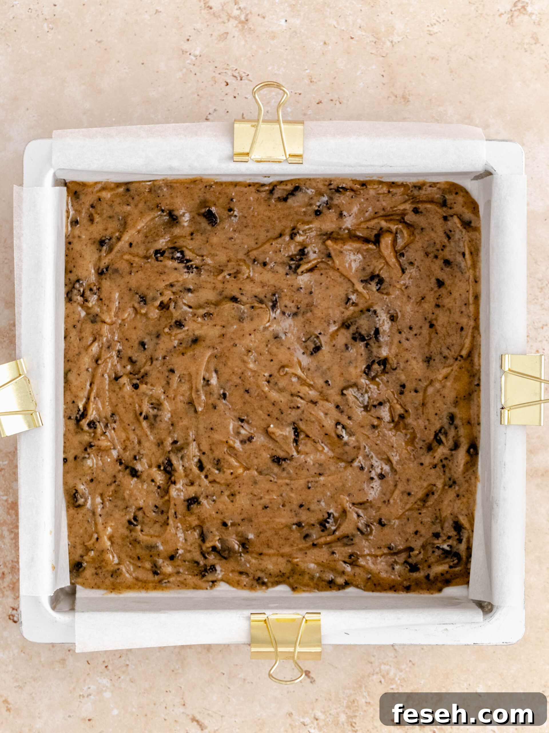 ¾ of the Oreo cookie dough in the bottom of a square baking pan and evened out.