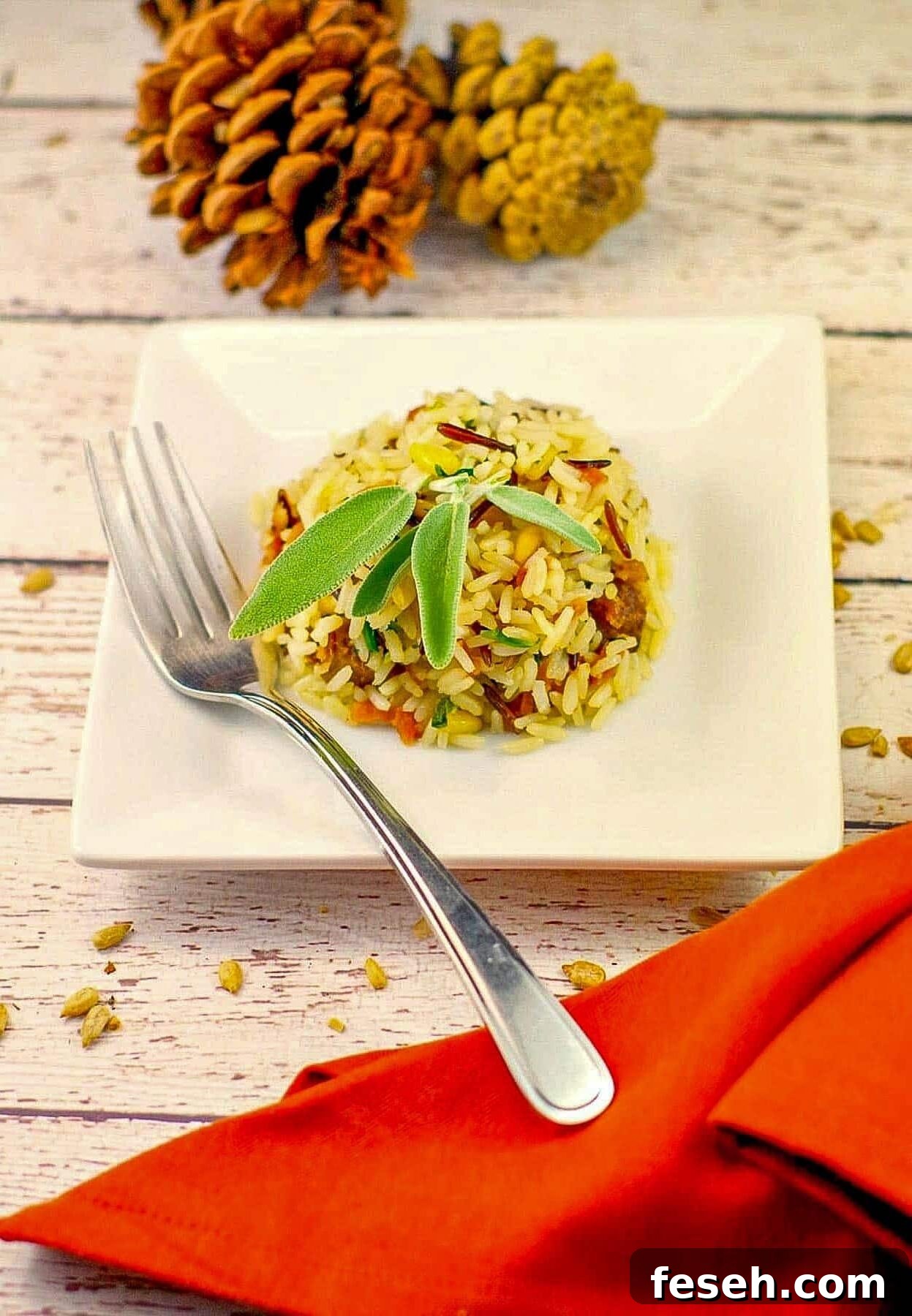 Apple rice shaped into a ball on a white plate with a fork