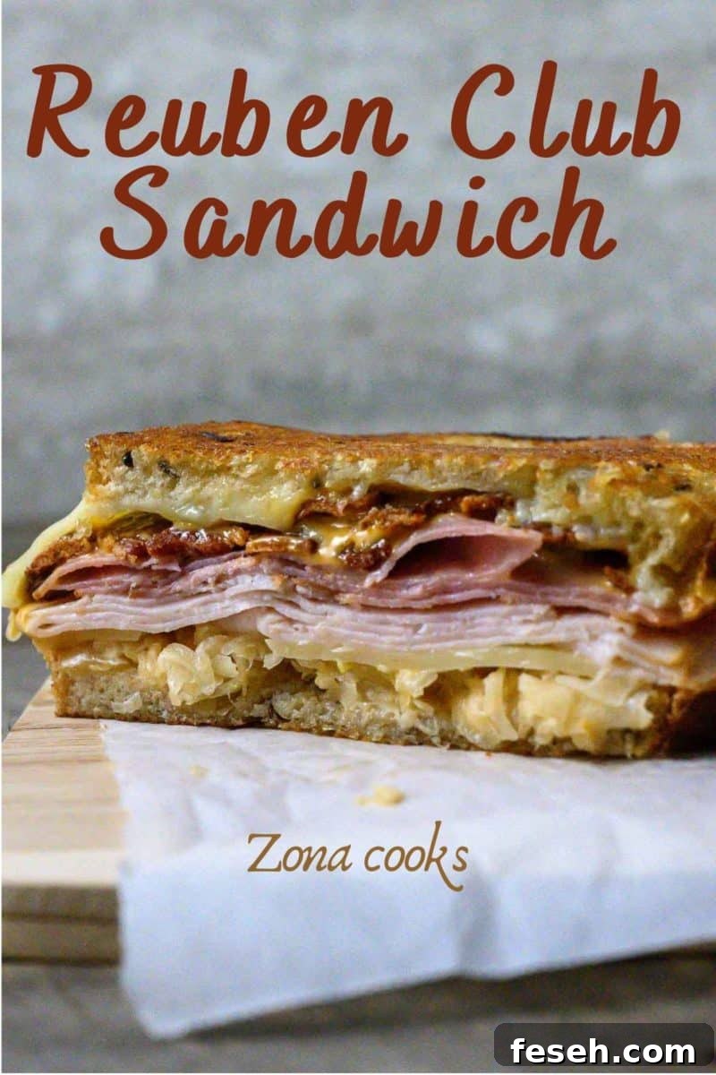 Reuben Sandwich with Ham cut open on parchment paper.