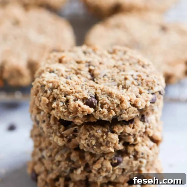 4 Breakfast Cookies stacked on top of eachother with more cookies in the background.