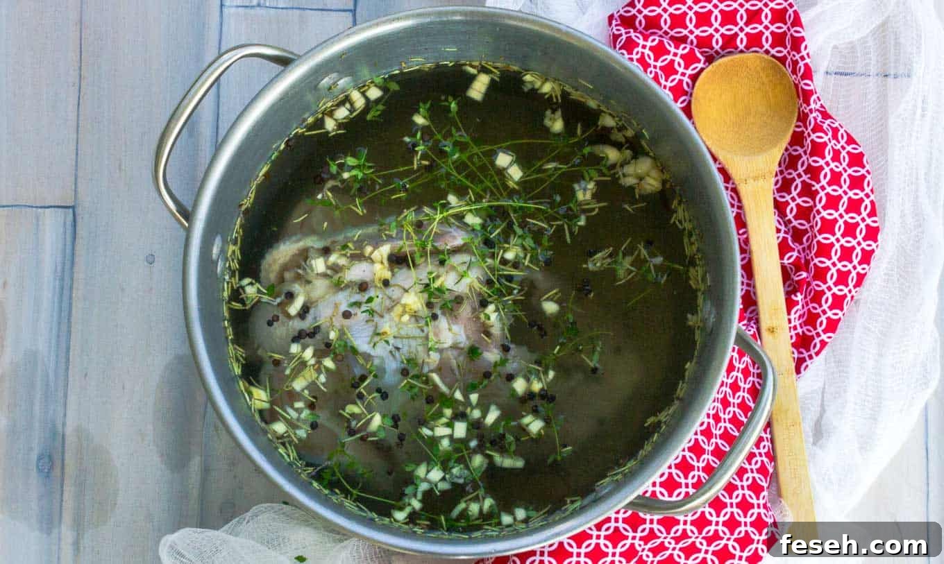 Simple Chicken Brine chicken turkey in a pot on red napkin with herbs and spices in brine water