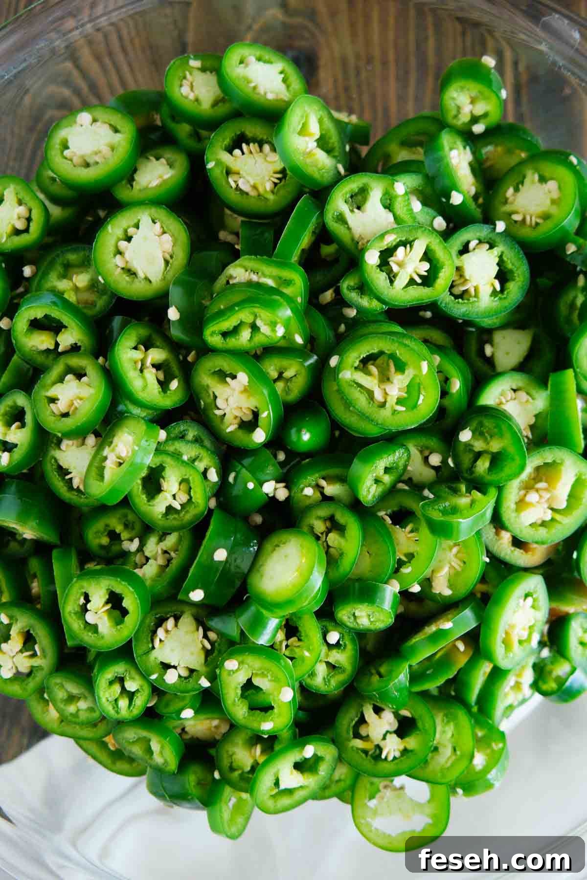 Raw jalapeños sliced in a bowl.