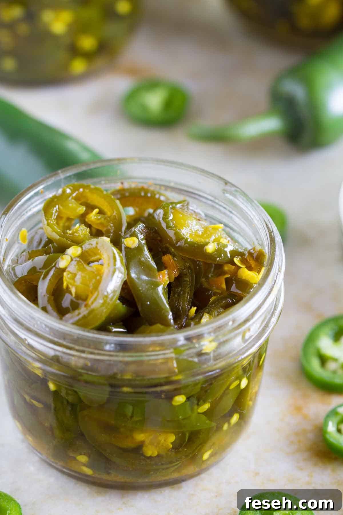 Small jar filled with candied jalapeños.