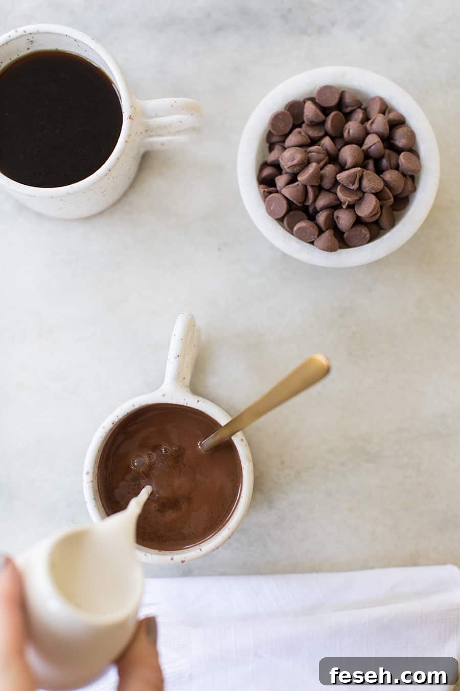 top down show of milk being poured into the caramel coffee