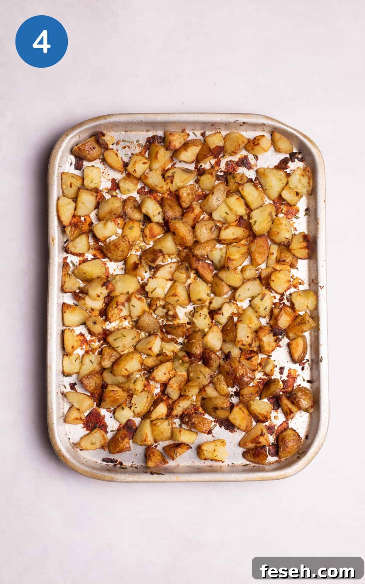golden potatoes combined with the crushed garlic, diced rosemary, and salt.