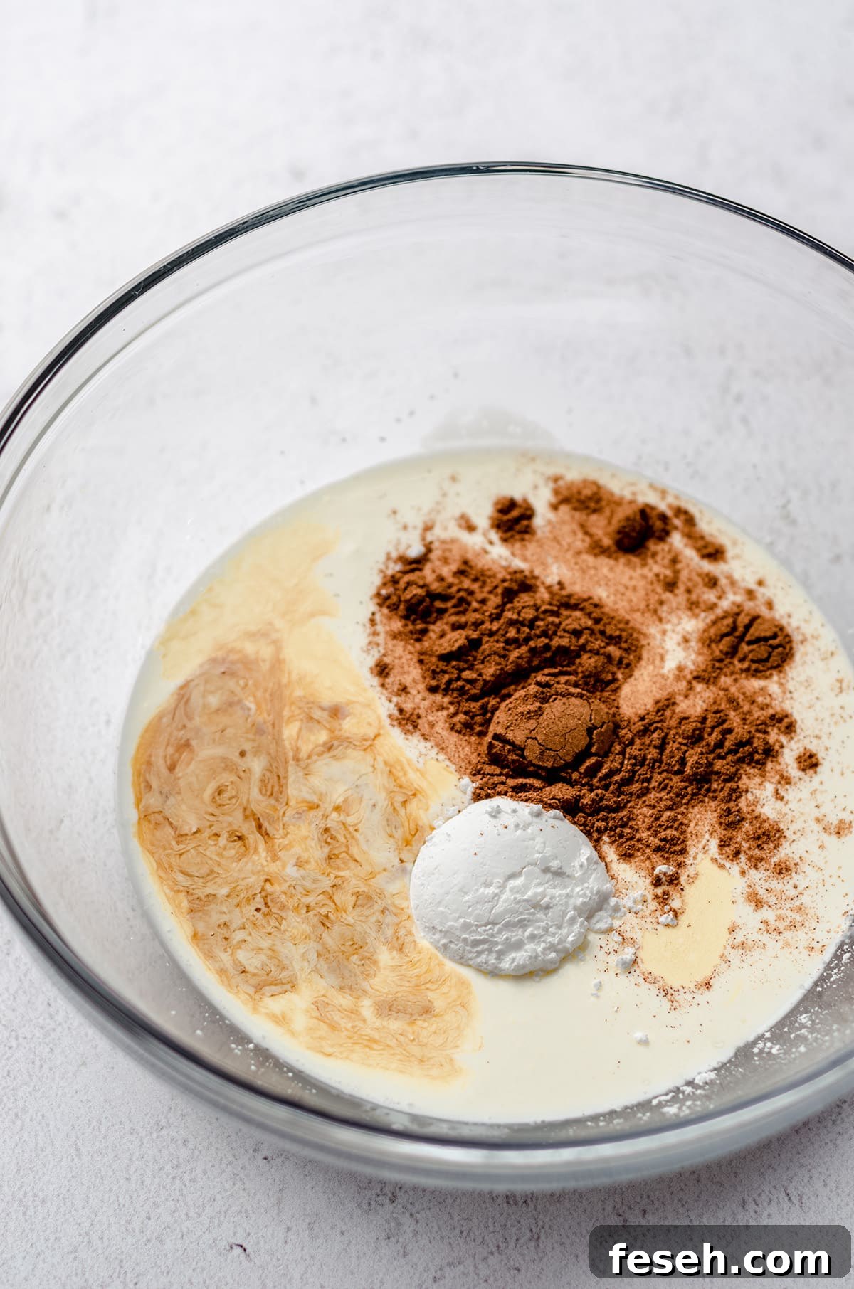 ingredients for pumpkin spice whipped cream in a glass bowl