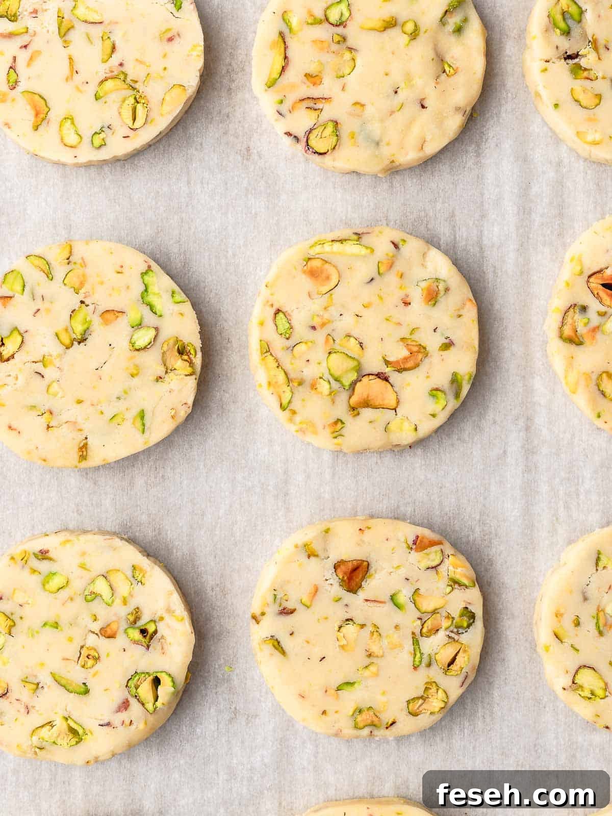Sliced shortbread cookies on a tray, ready to bake.