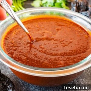 stirring red enchilada sauce with a metal spoon- featured image