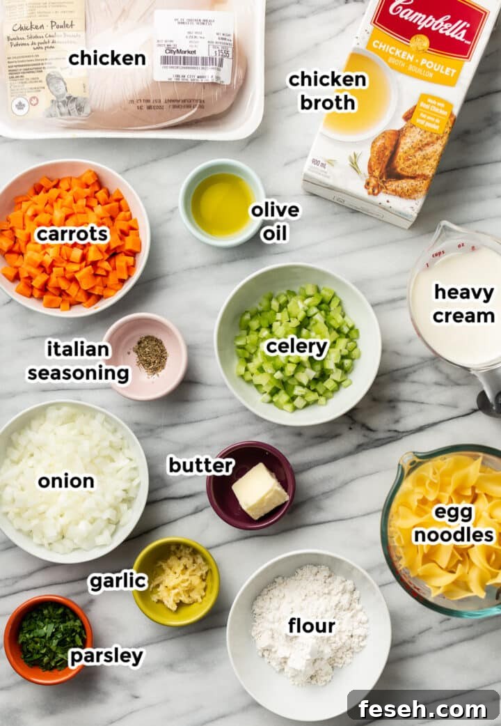 ingredients for creamy chicken noodle soup in prep bowls