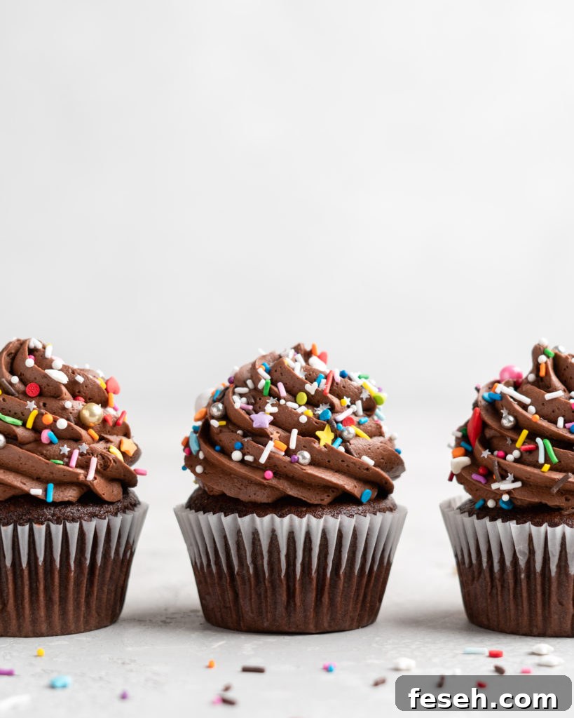These Chocolate Cupcakes are moist and fluffy, and jam-packed with rich chocolate flavor! Topped with a rich, buttery chocolate buttercream