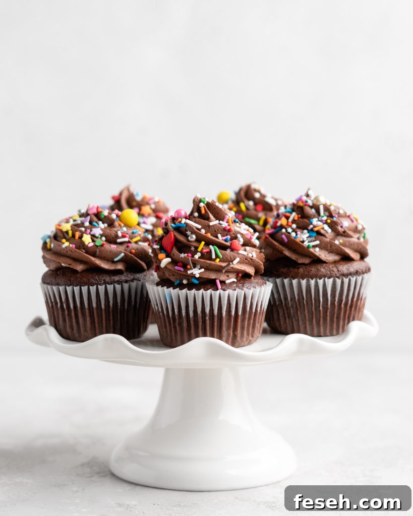 These Chocolate Cupcakes are moist and fluffy, and jam-packed with rich chocolate flavor! Topped with a rich, buttery chocolate buttercream