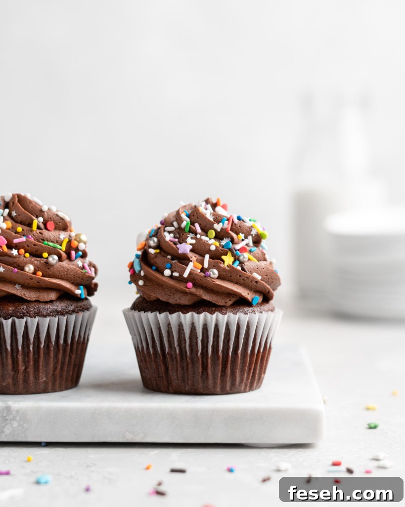 These Chocolate Cupcakes are moist and fluffy, and jam-packed with rich chocolate flavor! Topped with a rich, buttery chocolate buttercream