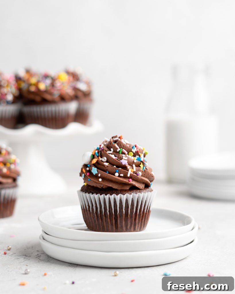 These Chocolate Cupcakes are moist and fluffy, and jam-packed with rich chocolate flavor! Topped with a rich, buttery chocolate buttercream