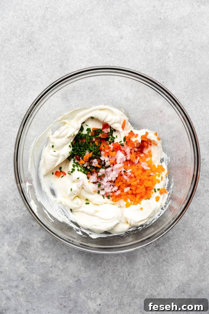 Chopped veggies on top of seasoned cream cheese.
