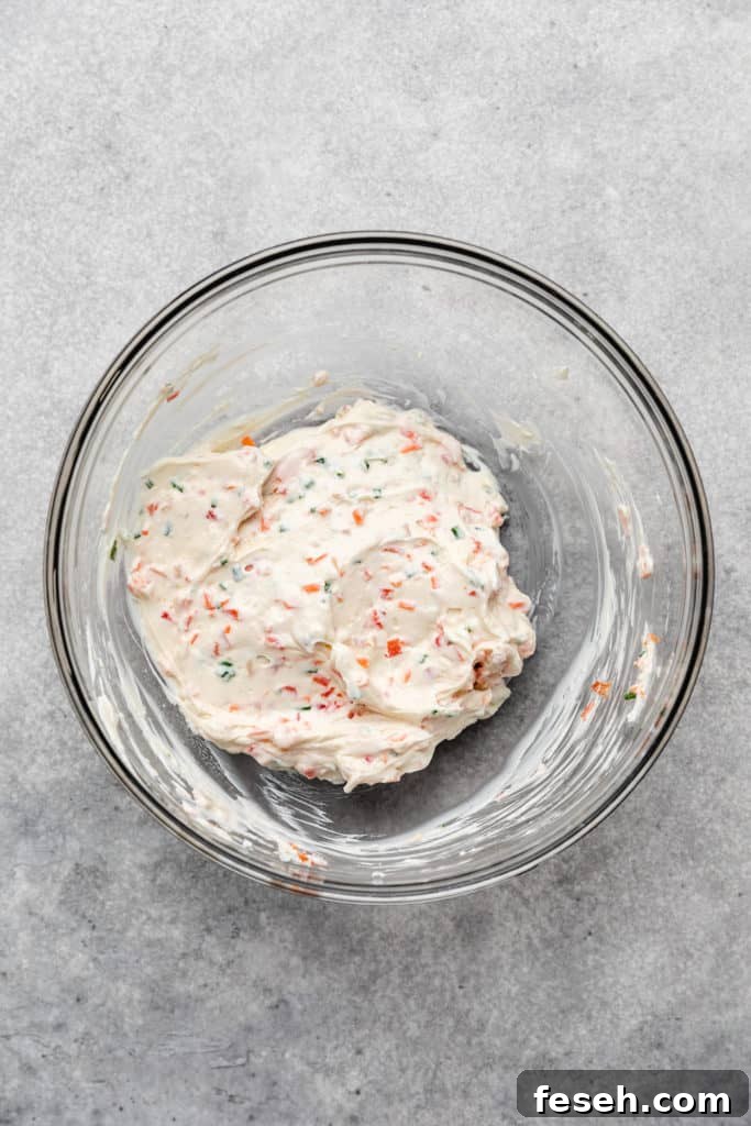 Garden vegetable cream cheese in a glass bowl.