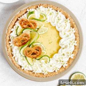 Key lime pie on white stucco background.