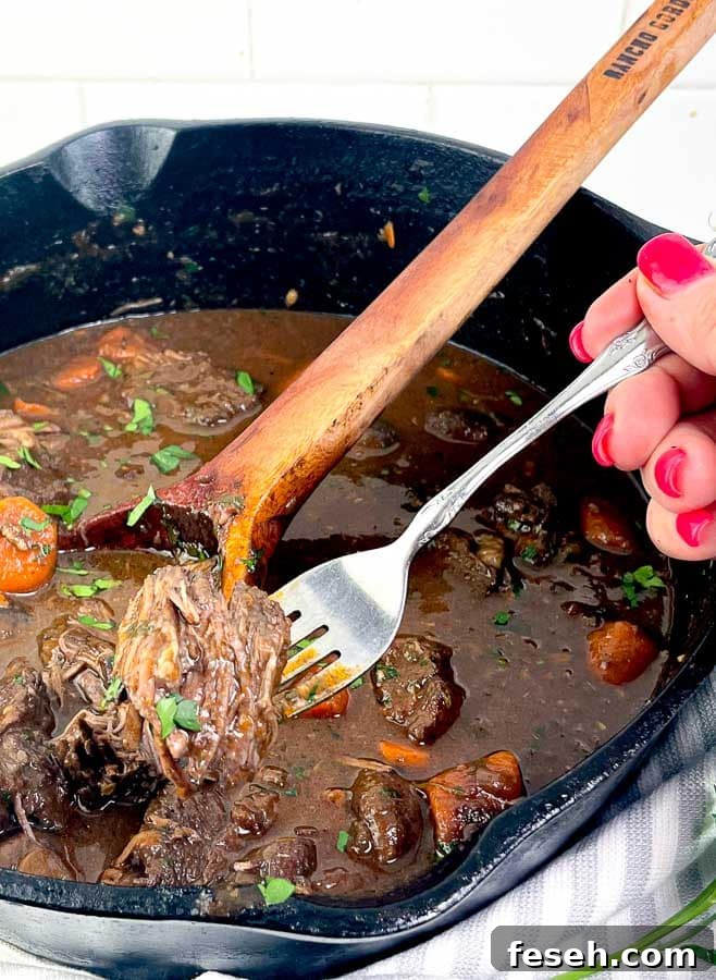 Red Wine Beef Stew with Mushrooms and Carrots with a fork of beef