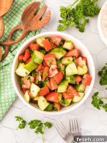 Tomatoes, cucumber and parsley in a salad bowl.