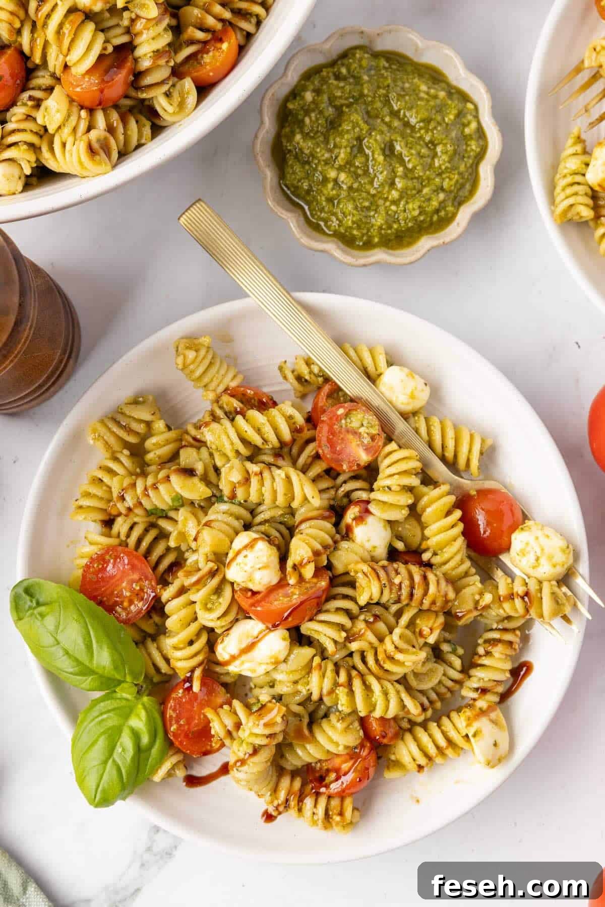 A serving of caprese pasta salad in a plate.