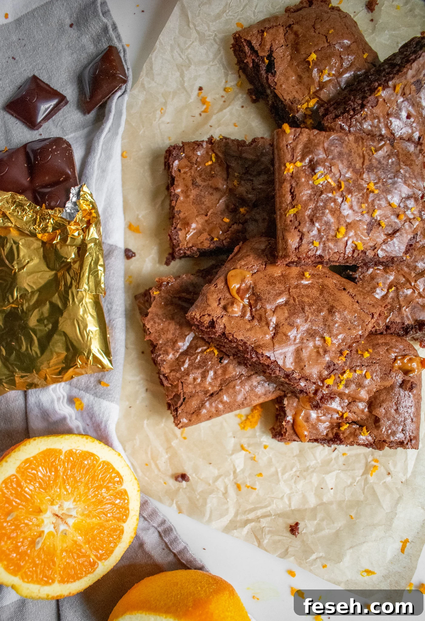 Chocolate orange toffee brownies on a piece of parchment paper.