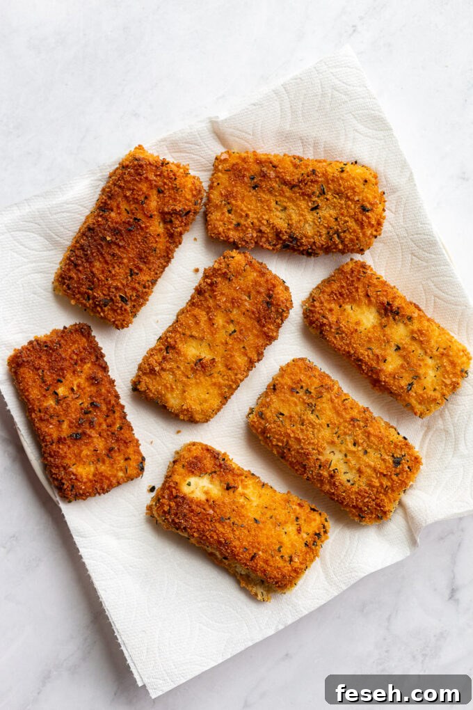 Breaded and fried tofu pieces on paper towels.