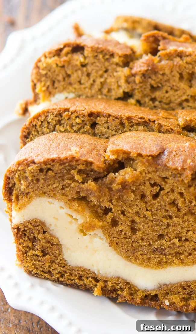 Cream Cheese Filled Pumpkin Bread - This delicious and moist pumpkin bread has a yummy cream cheese filling. It's so good and so, so pretty!