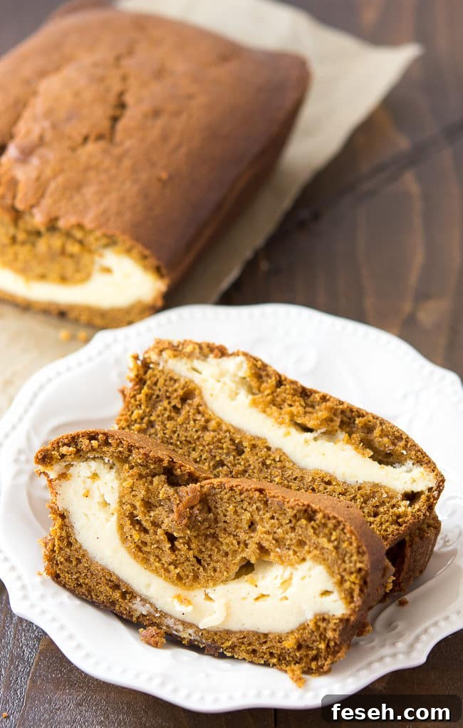 Cream Cheese Filled Pumpkin Bread - This delicious and moist pumpkin bread has a yummy cream cheese filling. It's so good and so, so pretty!