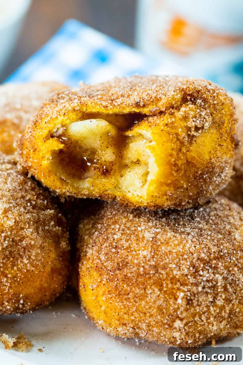 Close-up of Air Fryer Apple Pie Stuffed Biscuits with bite bitten out.