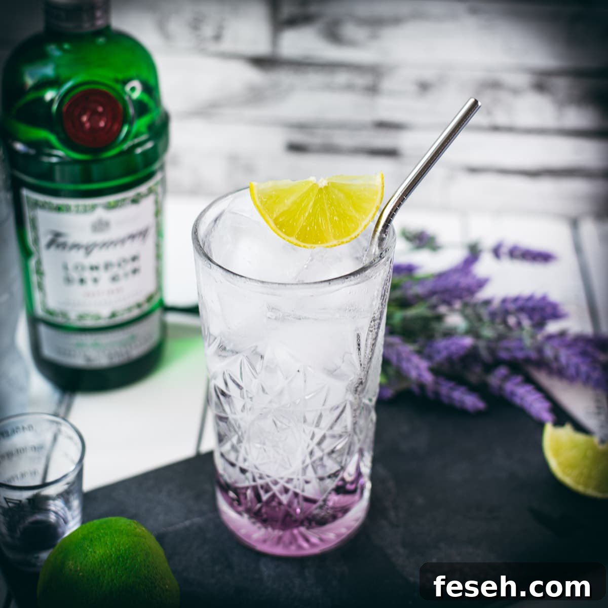 Highball glass filled with lavender gin and tonic