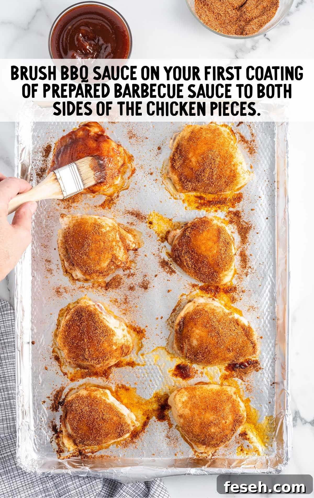 chicken thighs brushed with bbq sauce on a baking dish