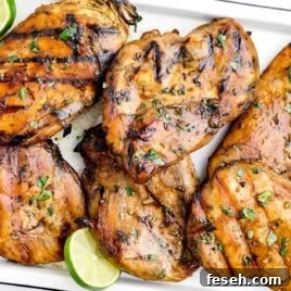 close up shot of Beer Marinated Chicken garnish with cilantro in a baking dish
