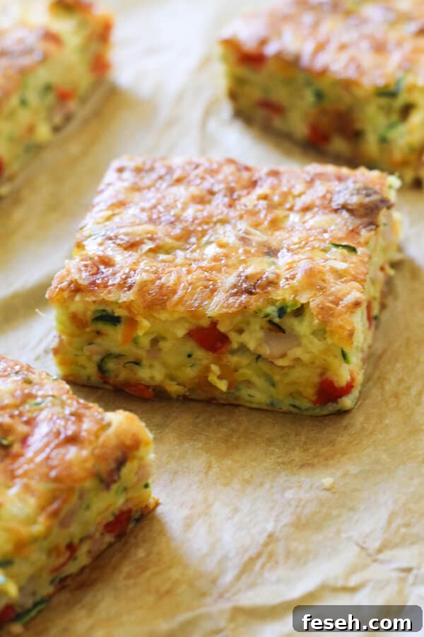 A piece of Zucchini and Bacon Slice on baking paper. 