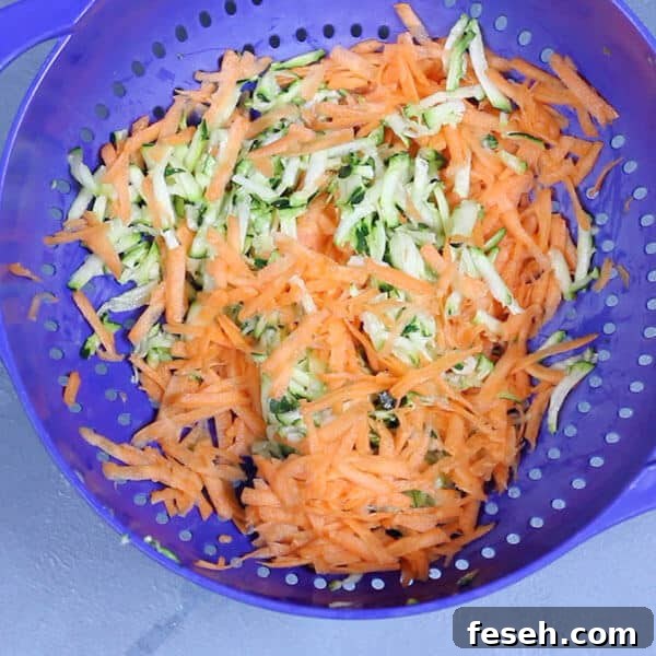 shredded carrot and zucchini in a colander