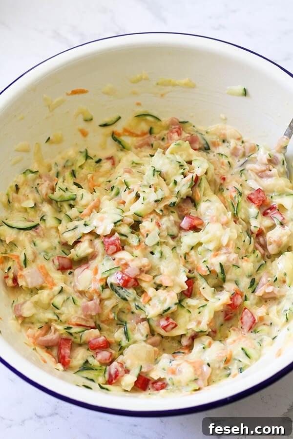 Zucchini and Bacon Slice ingredients in a white mixing bowl. 