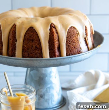 Apple Bundt Cake with brown sugar glaze on a metal cake stand