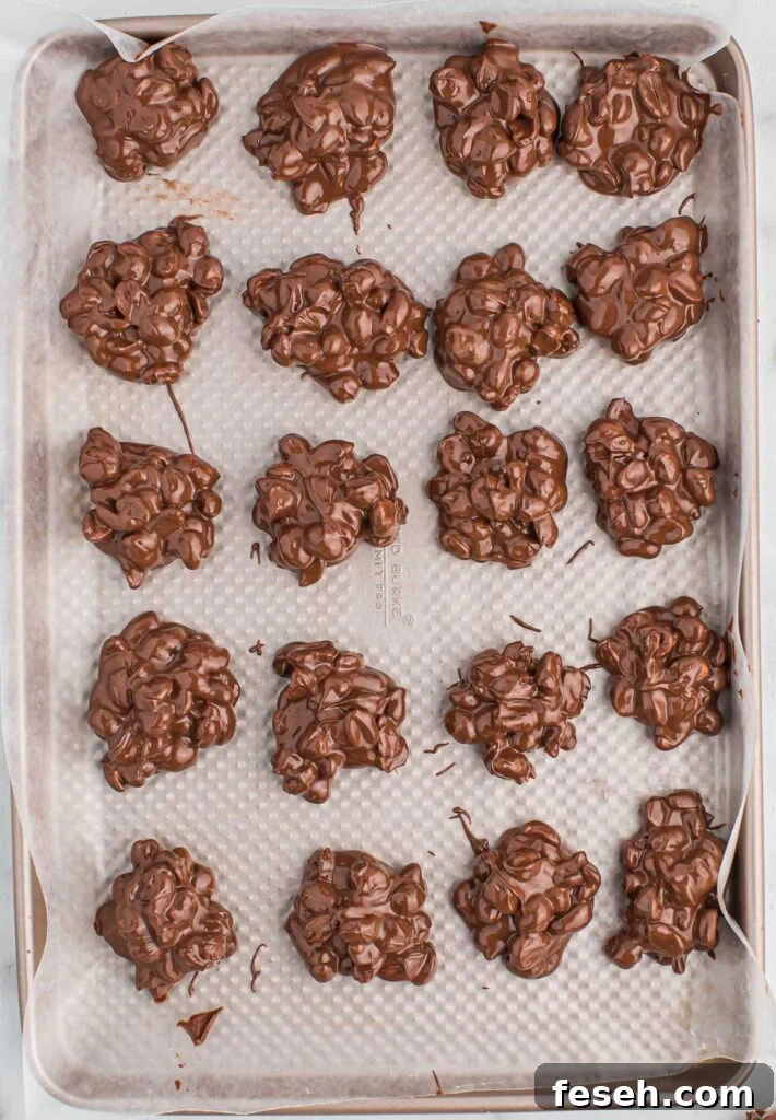 crock pot peanut clusters on a baking sheet