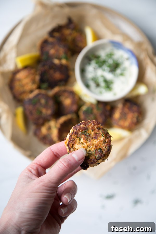 hand holding pan fried easy canned salmon cake